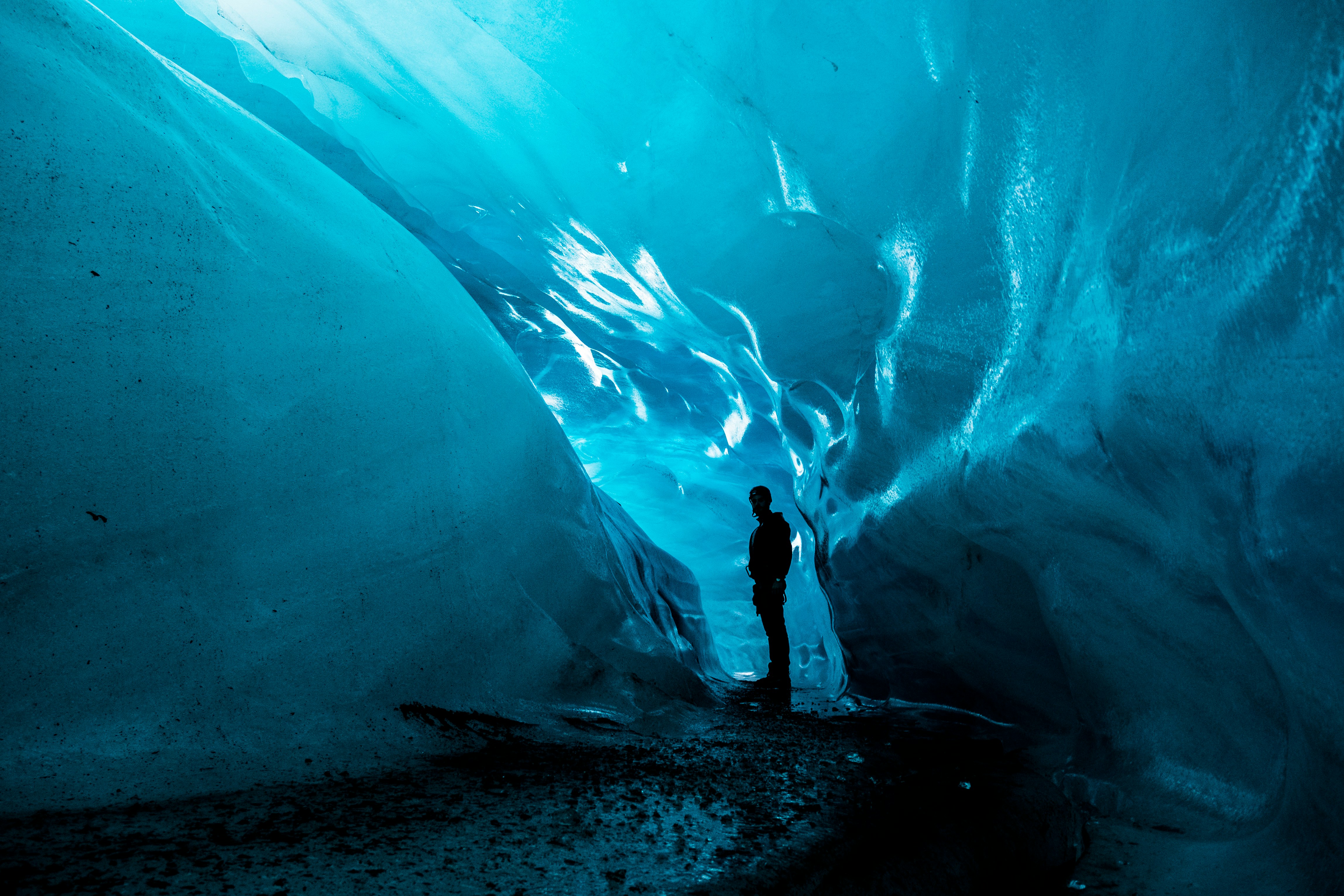 Tourist exploring an ice cave in Iceland.