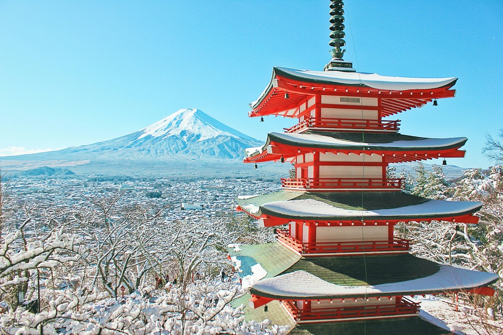 red and white pagoda temple new snow covered Mt. Fuji