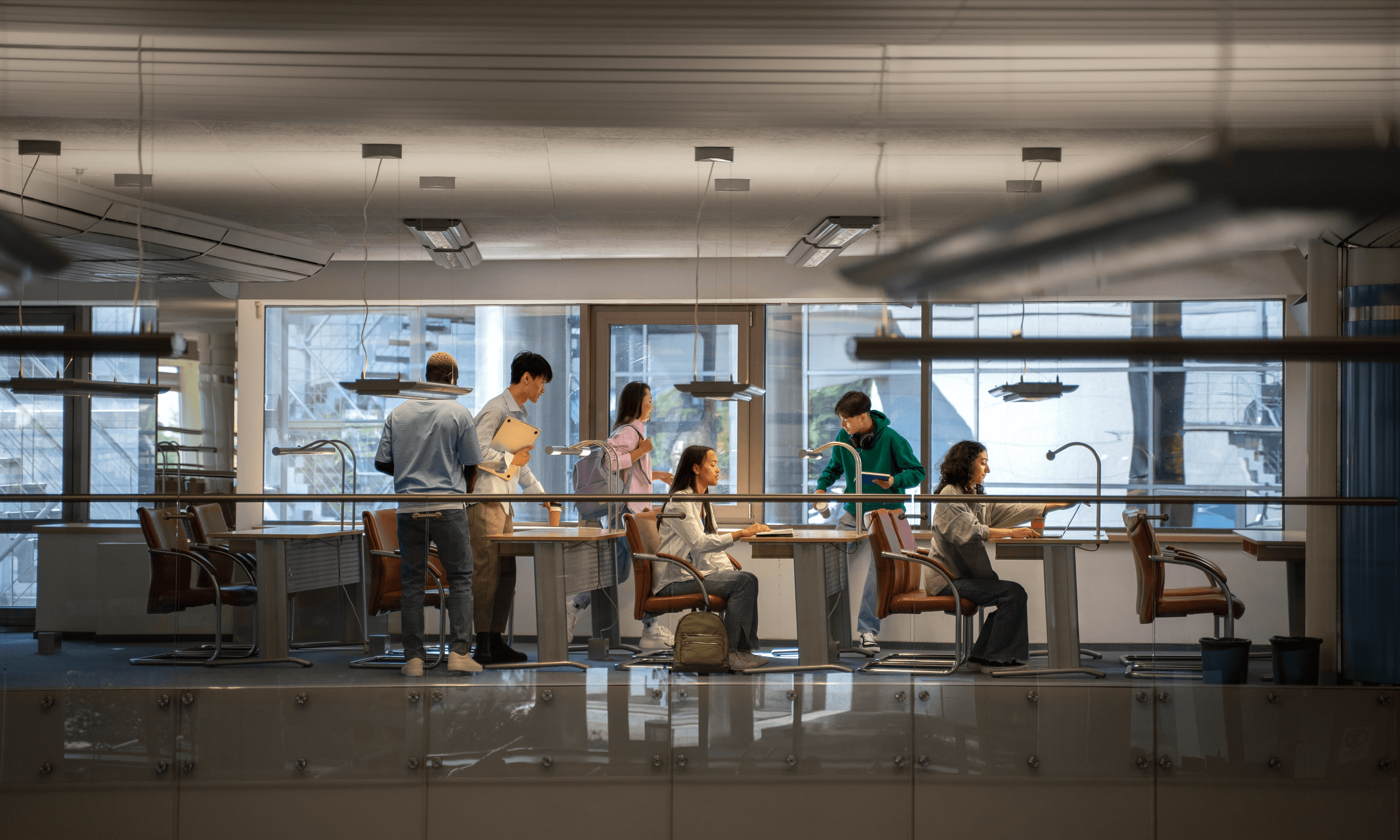 People collaborating in a modern open-plan office, illustrating teamwork, innovation and technology-focused workflows.