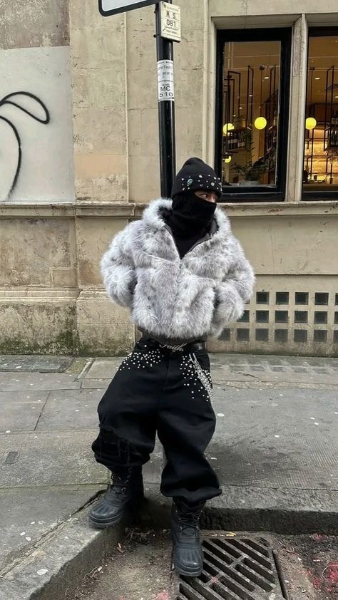 Stylish individual with platinum blonde hair, sunglasses, and leather outfit