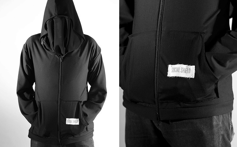A photo of someone wearing a black hoodie with a white label on it.