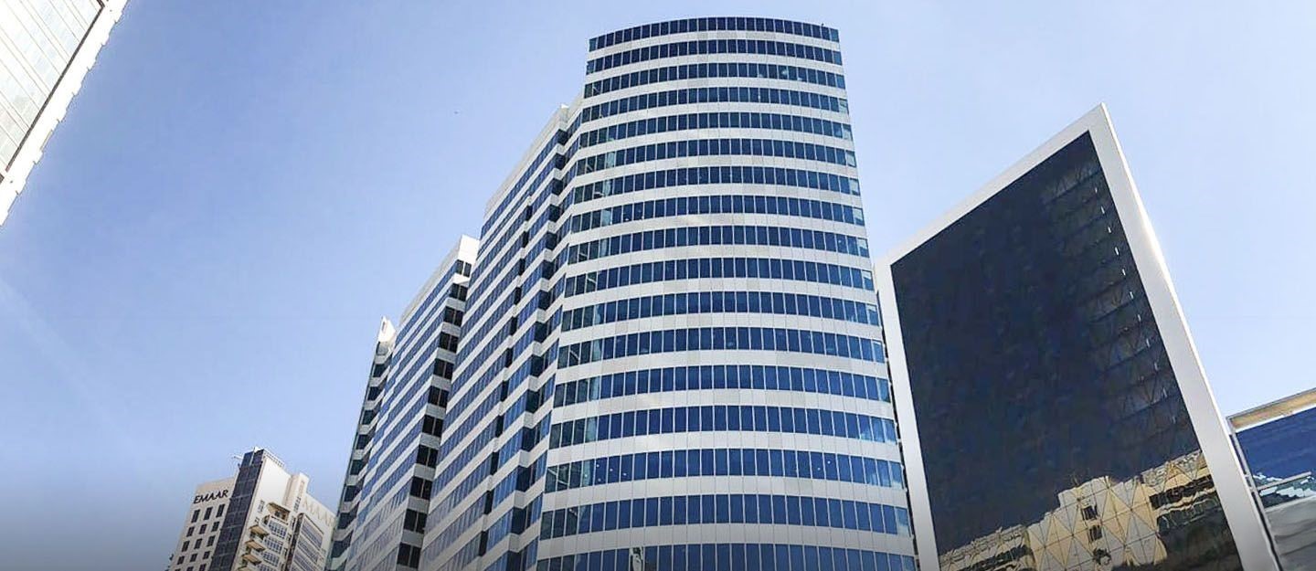 Modern glass facade of Opal Tower in Business Bay, a prime location for commercial real estate services.
