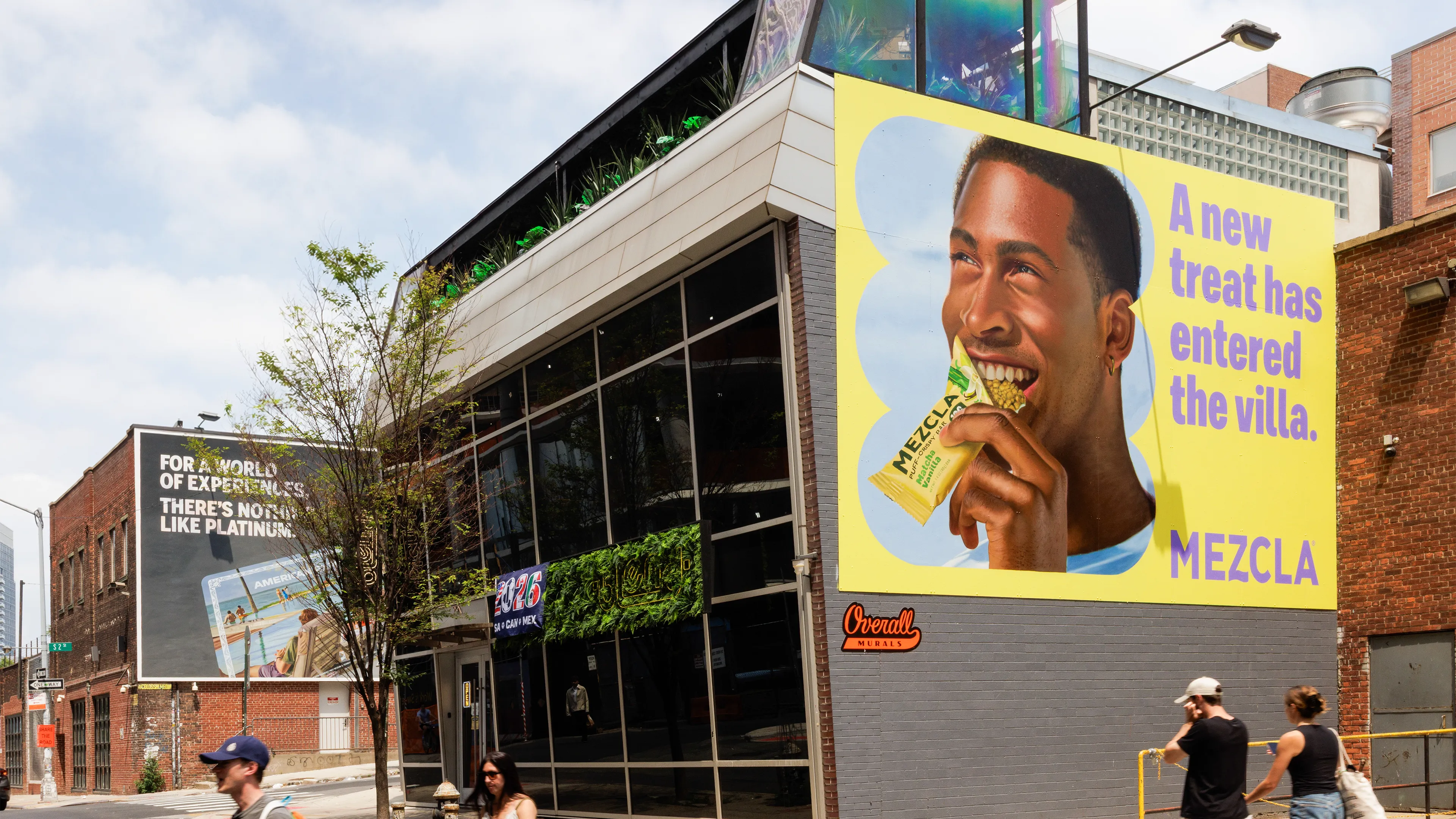 Mezcla hand-painted mural on a Brooklyn building, man eating a Matcha Vanilla bar, painted by Overall Murals