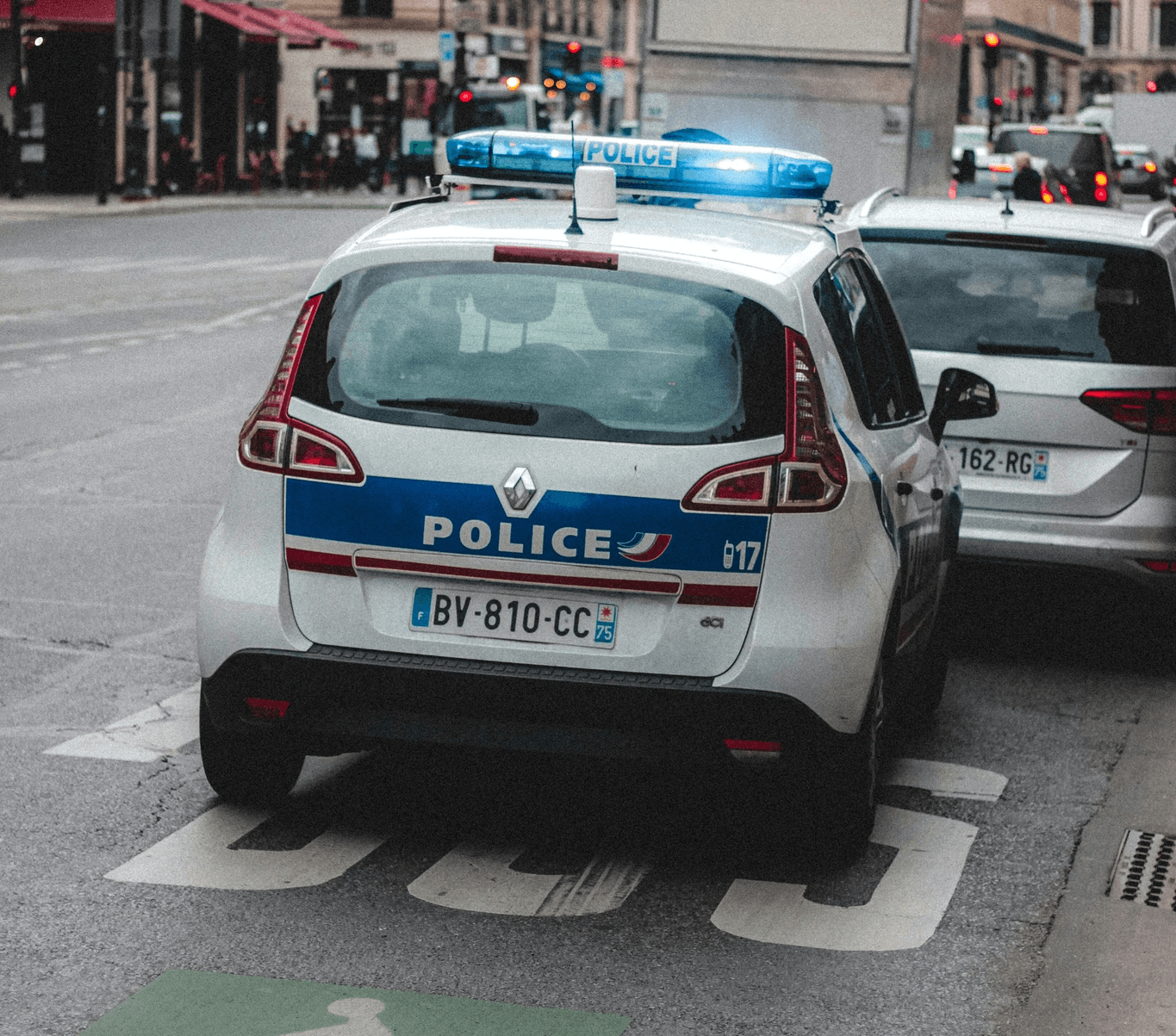 white and blue police car on road during daytime