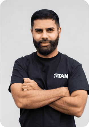 Wahid Muhammad, CTO of TITAN PMR, wearing a black TITAN t-shirt and smiling with arms crossed