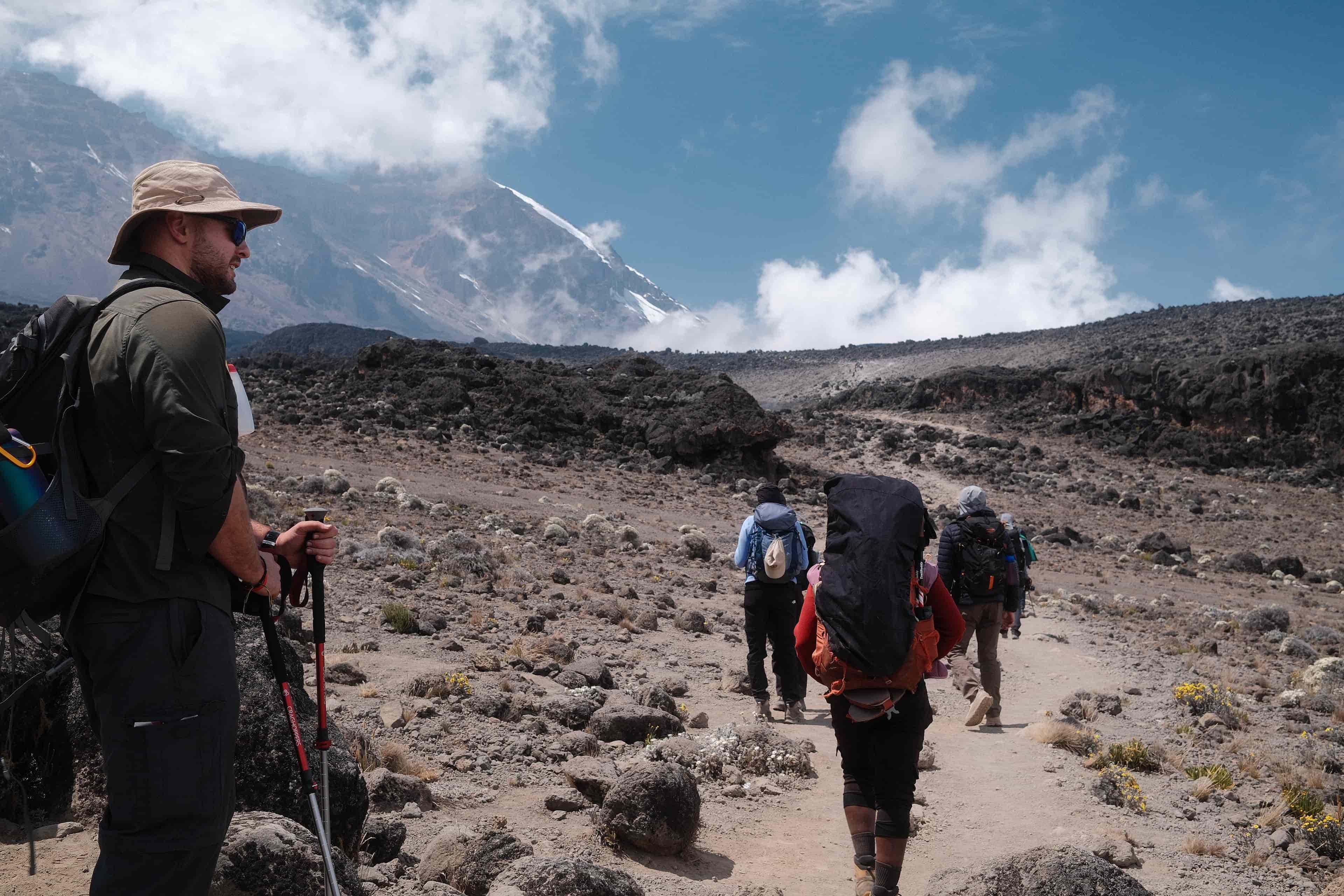 Kilimanjaro porter carrying client duffel bag on the Lemosho route