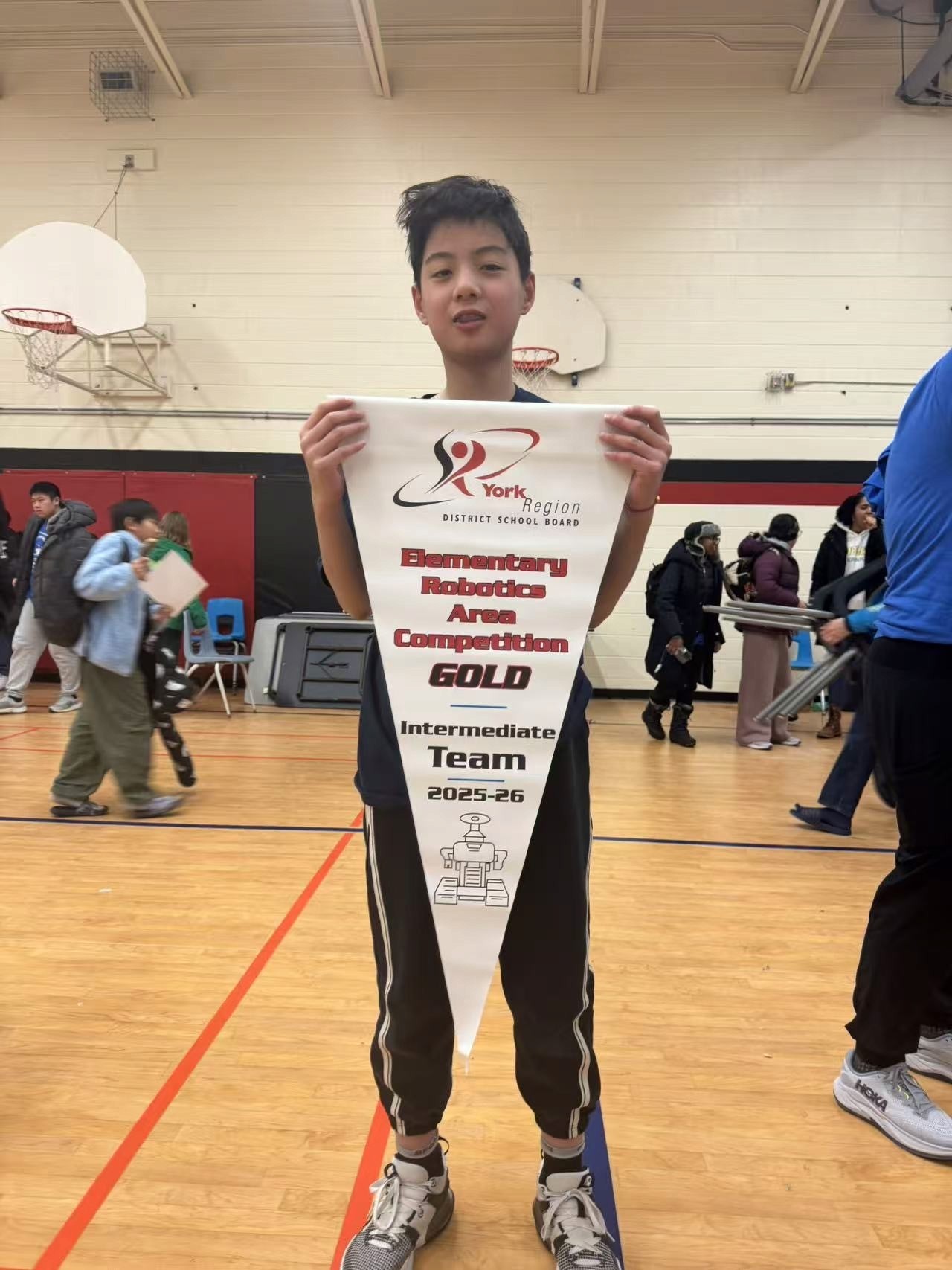 Samuel Pan holds the championship banner after Rick Hansen Public School’s 1st Place finish at the York Region Skills Challenge Intermediate LEGO Robotics Challenge Area Competition.