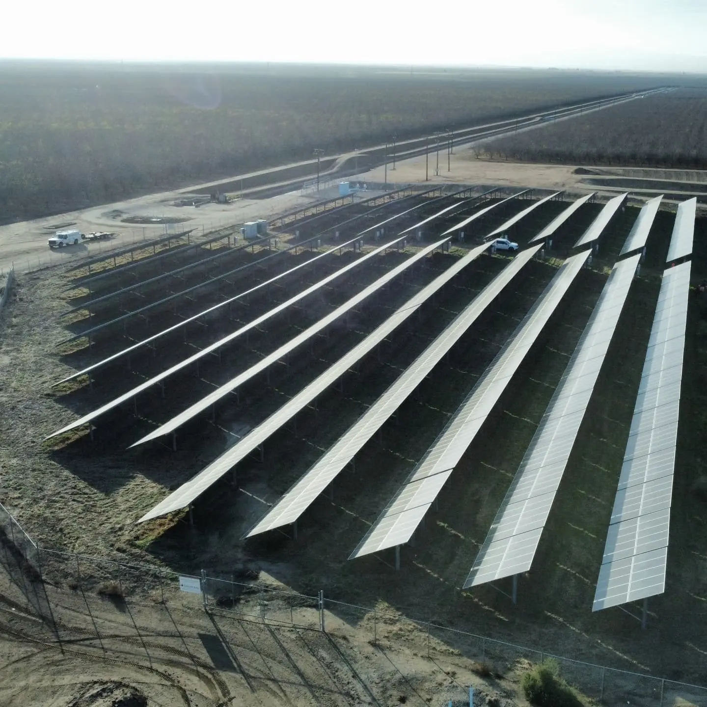 Aerial view of long ground-mount solar rows in an open field | Premier Solar Service, serving Fresno, CA
