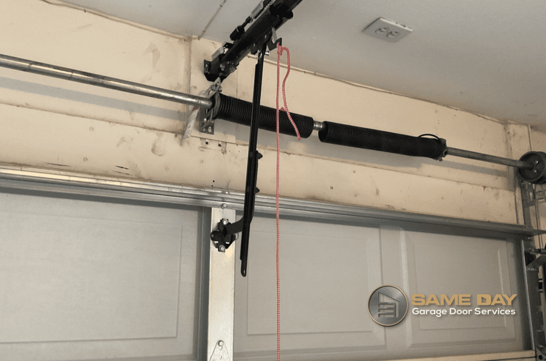 How to Determine If Your Garage Door Springs Are Faulty|Peter Brown, owner and technician at Same Day Garage Door Services, performs some repairs while inspecting if garage door spring are faulty|Peter Brown, owner and technician at Same Day Garage Door Services, performs some repairs while inspecting if garage door spring are faulty