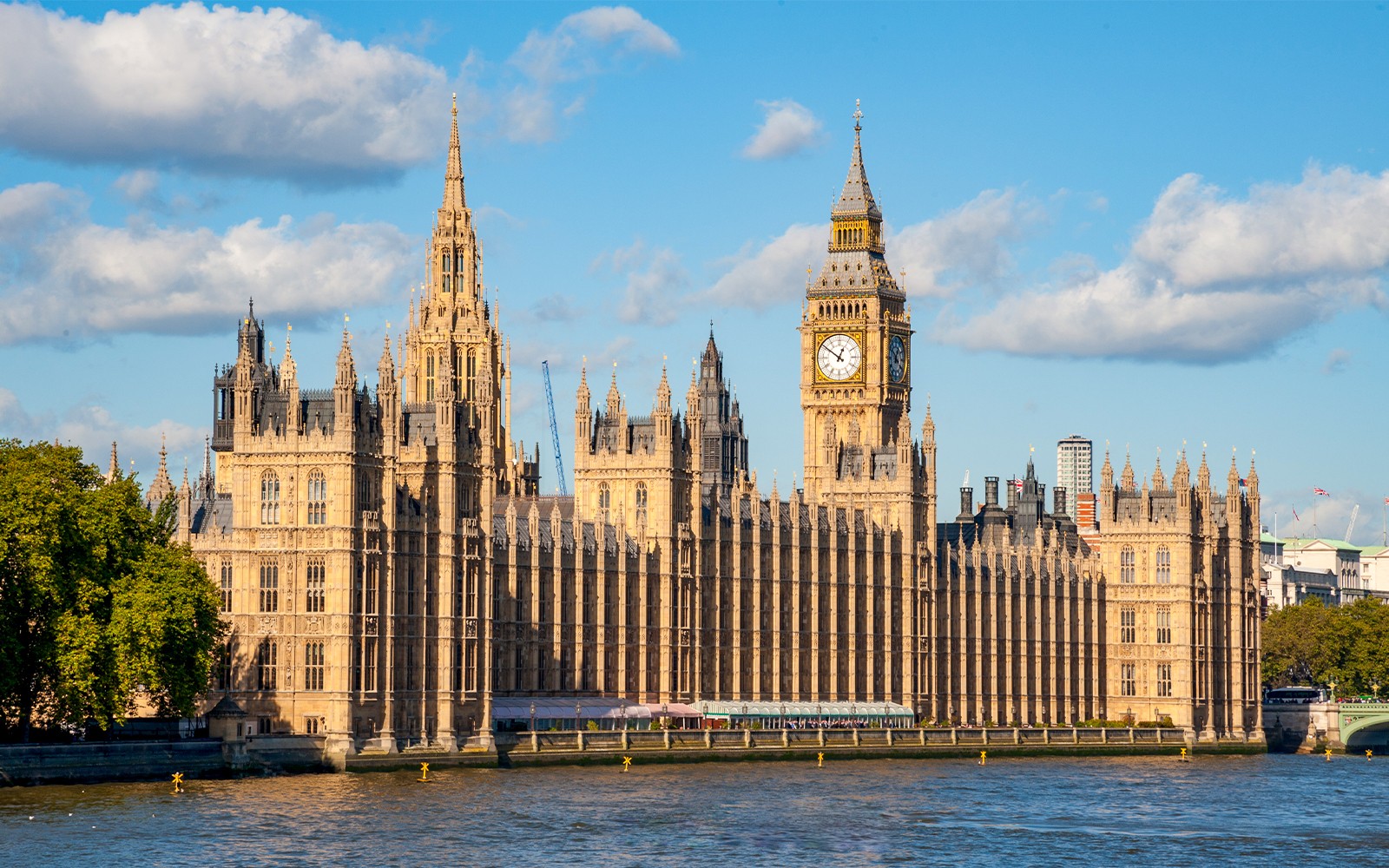 Houses of Parliament and Westminster Abbey in London, UK, viewed from the River Thames.