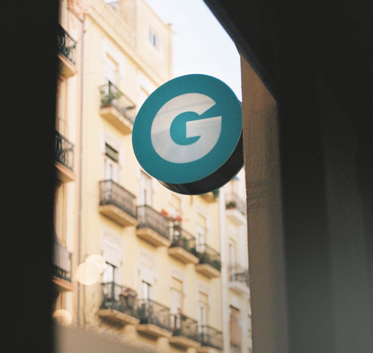 Photograph of the Gusta logo on the sign outside the office.