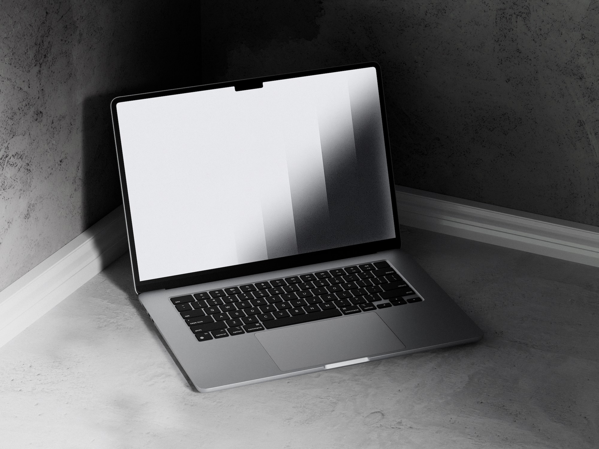 A sleek, modern laptop with a thin silver body and a large screen displaying a gradient pattern is positioned open on a minimalist, light gray cement floor, set against matching gray textured walls in a corner, enhancing its contemporary design.