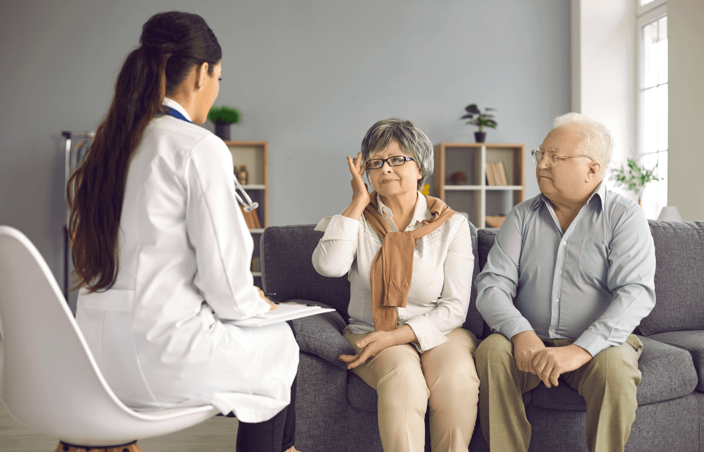 Doctor Listening to Senior Patients Sharing Their Health Concerns during Home Visit