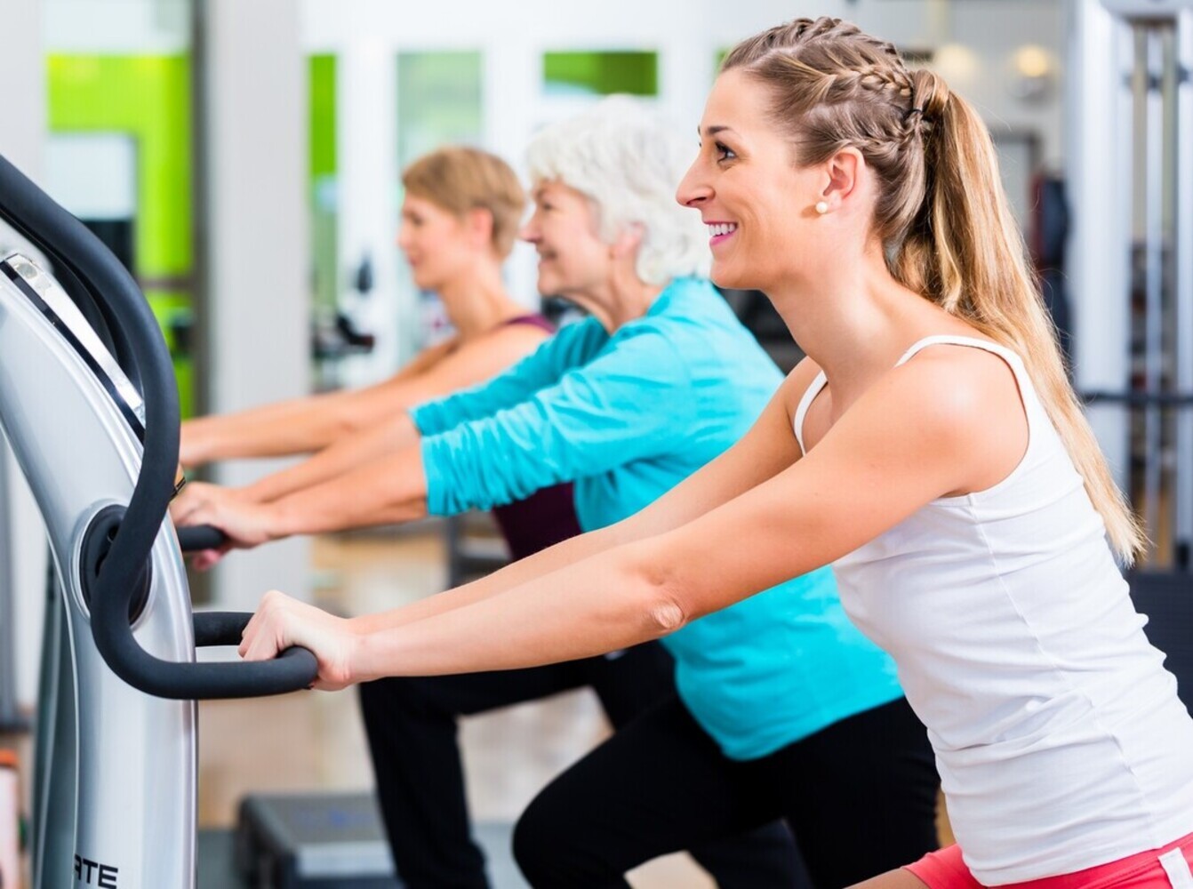 group of women working out to get vibration plate weight loss results at the gym
