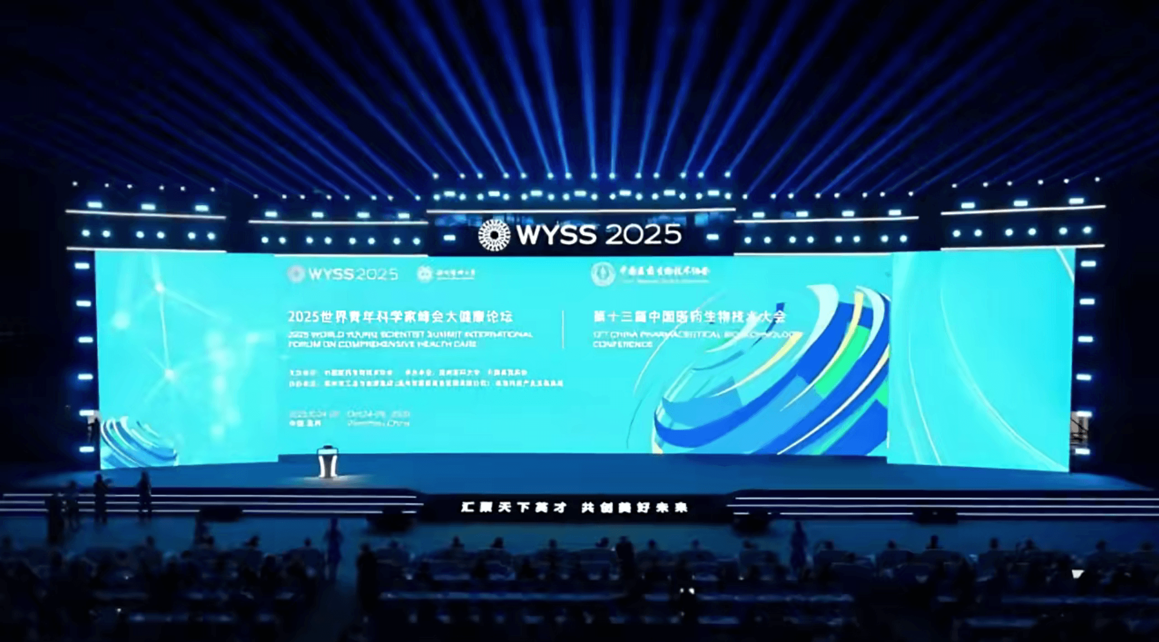 A cozy workspace featuring a wooden desk, a lamp, books, and a plant, illuminated by warm sunlight.