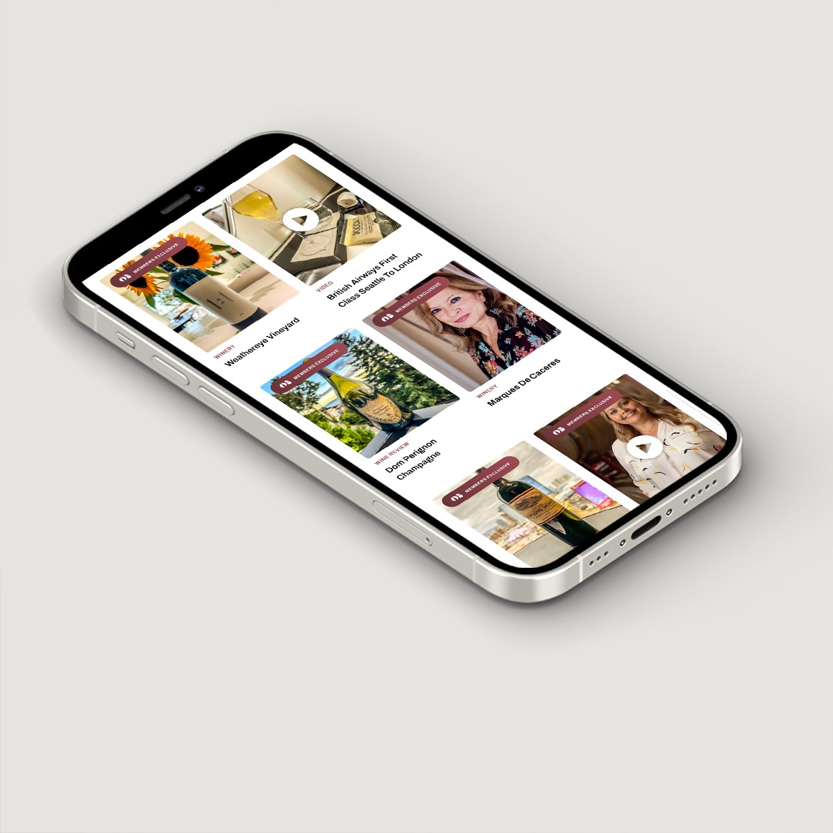 Smartphone mockup displaying mobile site with featured wine reviews and lifestyle articles.