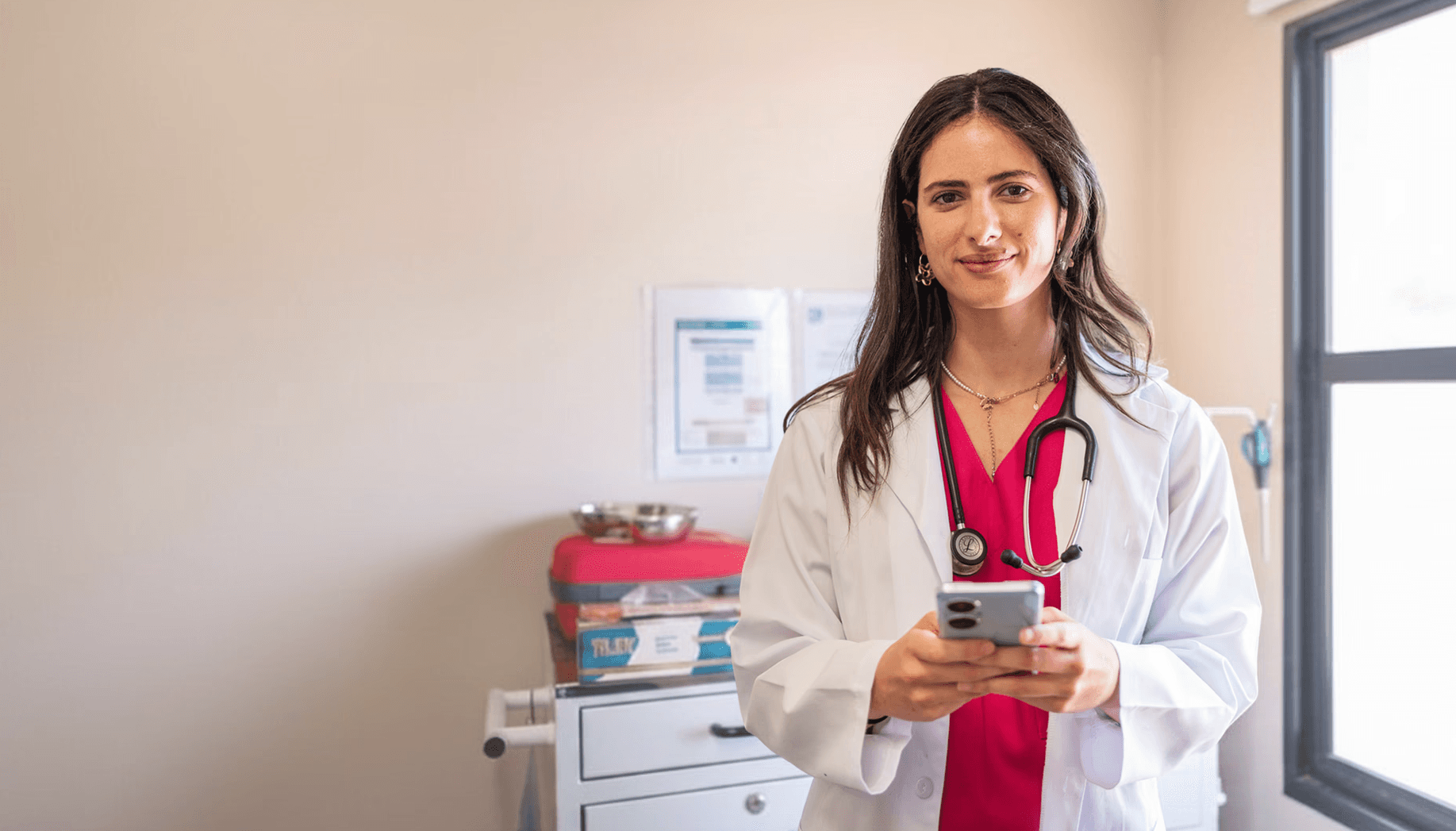 Photo of a female doctor looking at her phone. 
