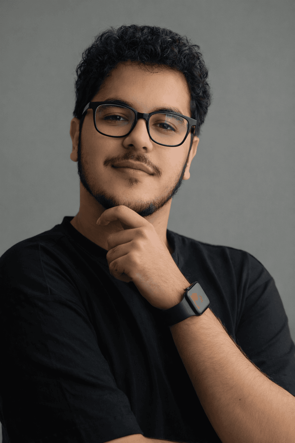 A woman with dark hair wearing a black top, looking confidently at the camera.