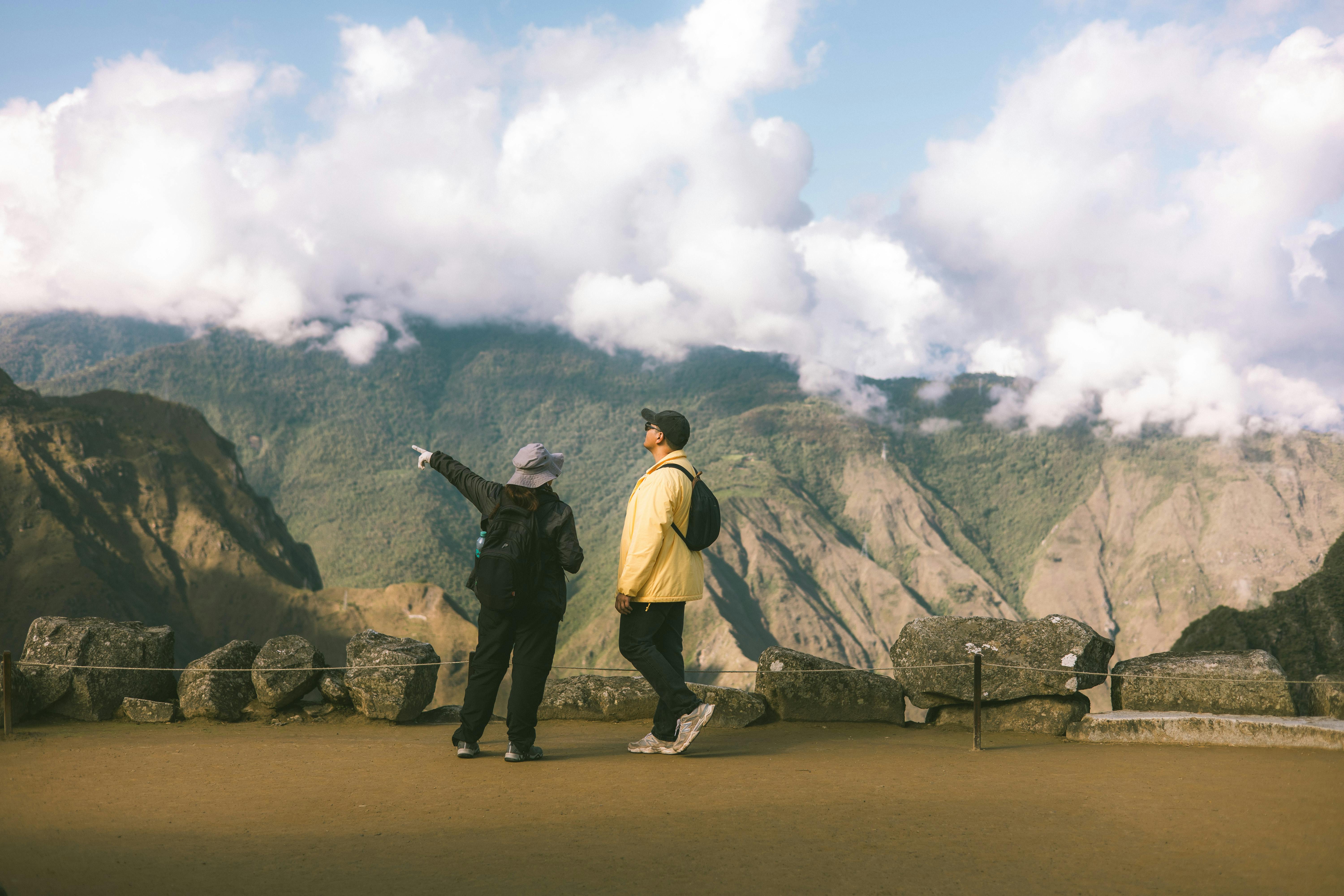 two people in a workspace working on their laptops