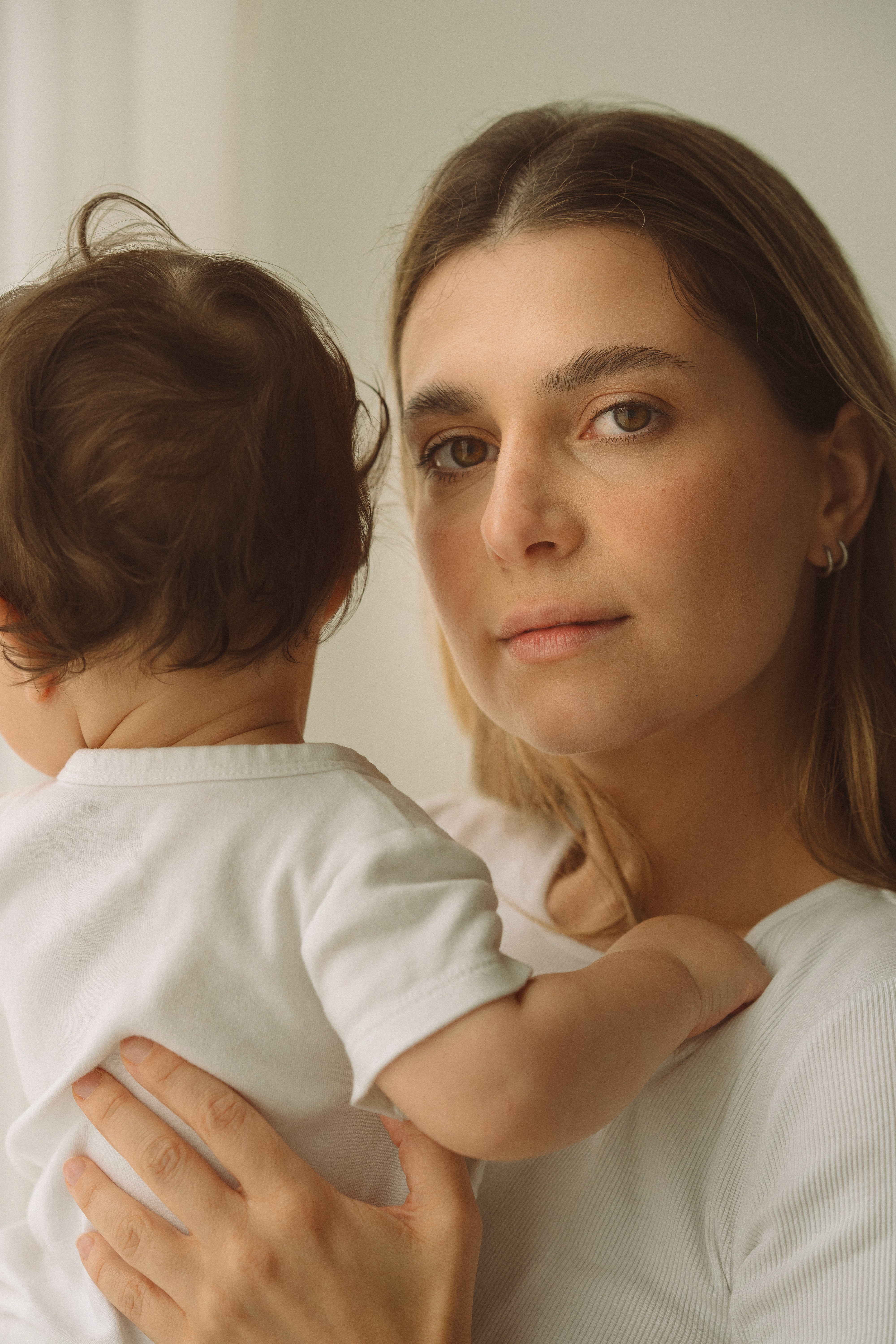 A mother playing with her young children.