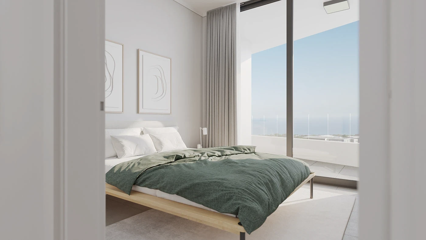 Minimalist bedroom with wooden platform bed dressed in teal-green bedding, white walls, built-in wardrobes, and soft natural lighting creating a serene atmosphere