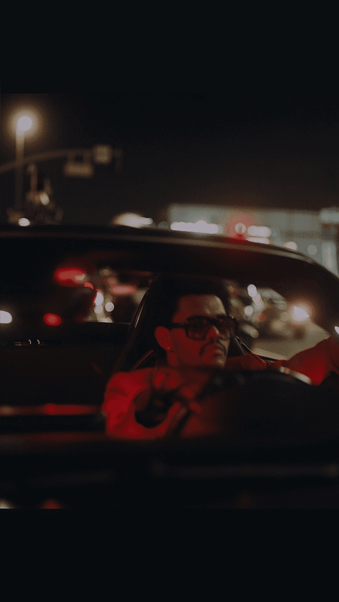 two people sitting on a bench looking at a mountain