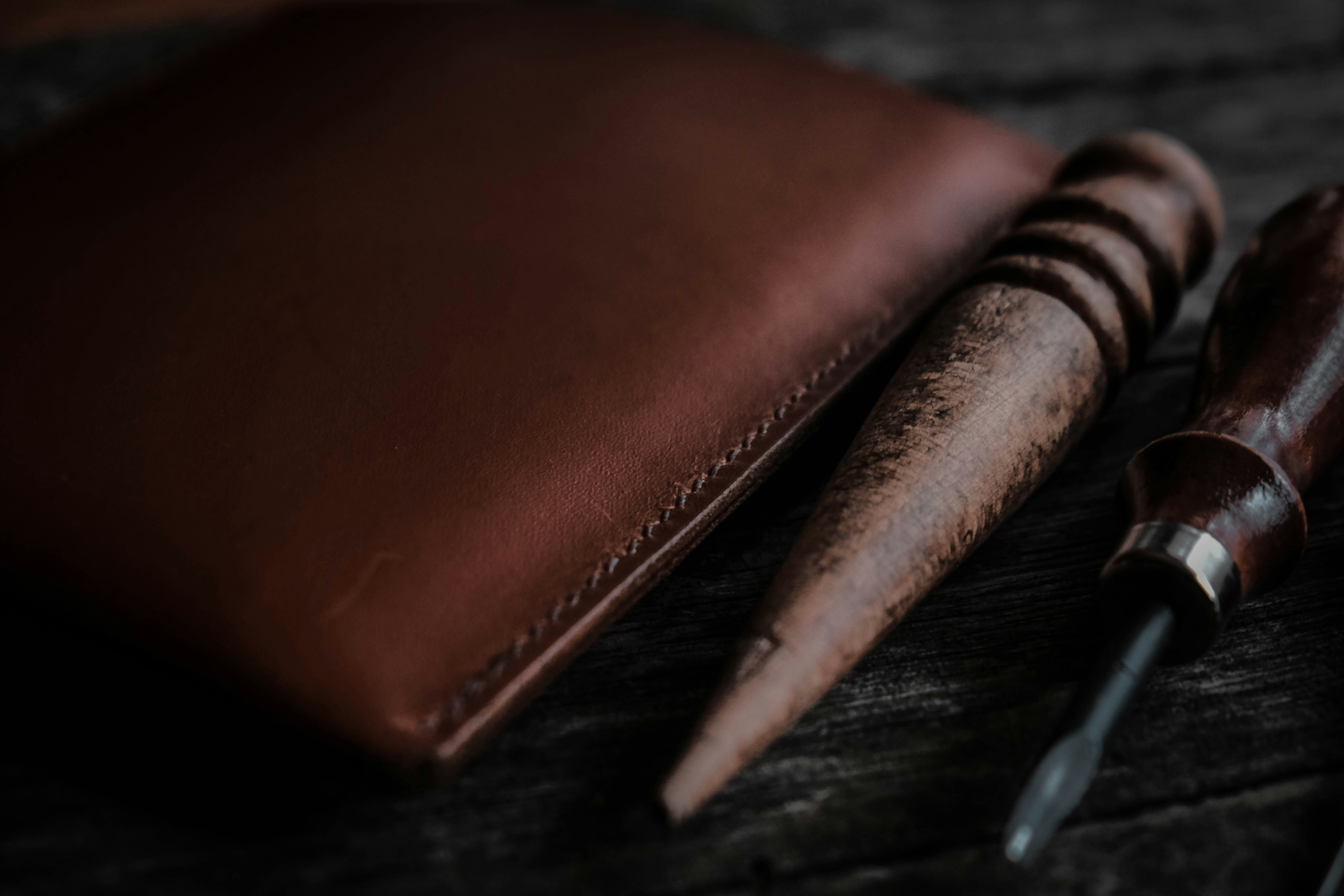 Audience silhouettes in front of a large stage with illuminated screens and lighting at a live event.