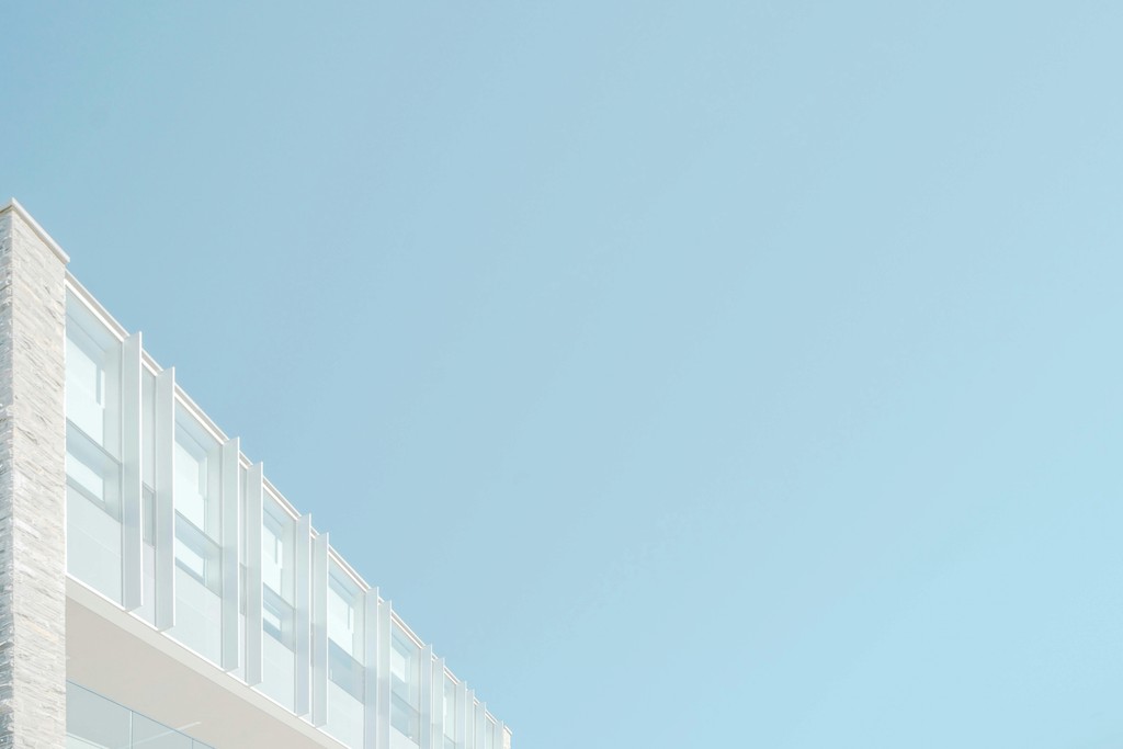 two people in a workspace working on their laptops 