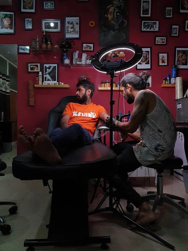 Tattoo artist in Bangalore inking a client at Fred's tattoo studio in Bangalore, Koramangala, showcasing artwork at one of the best tattoo places in Bangalore.
