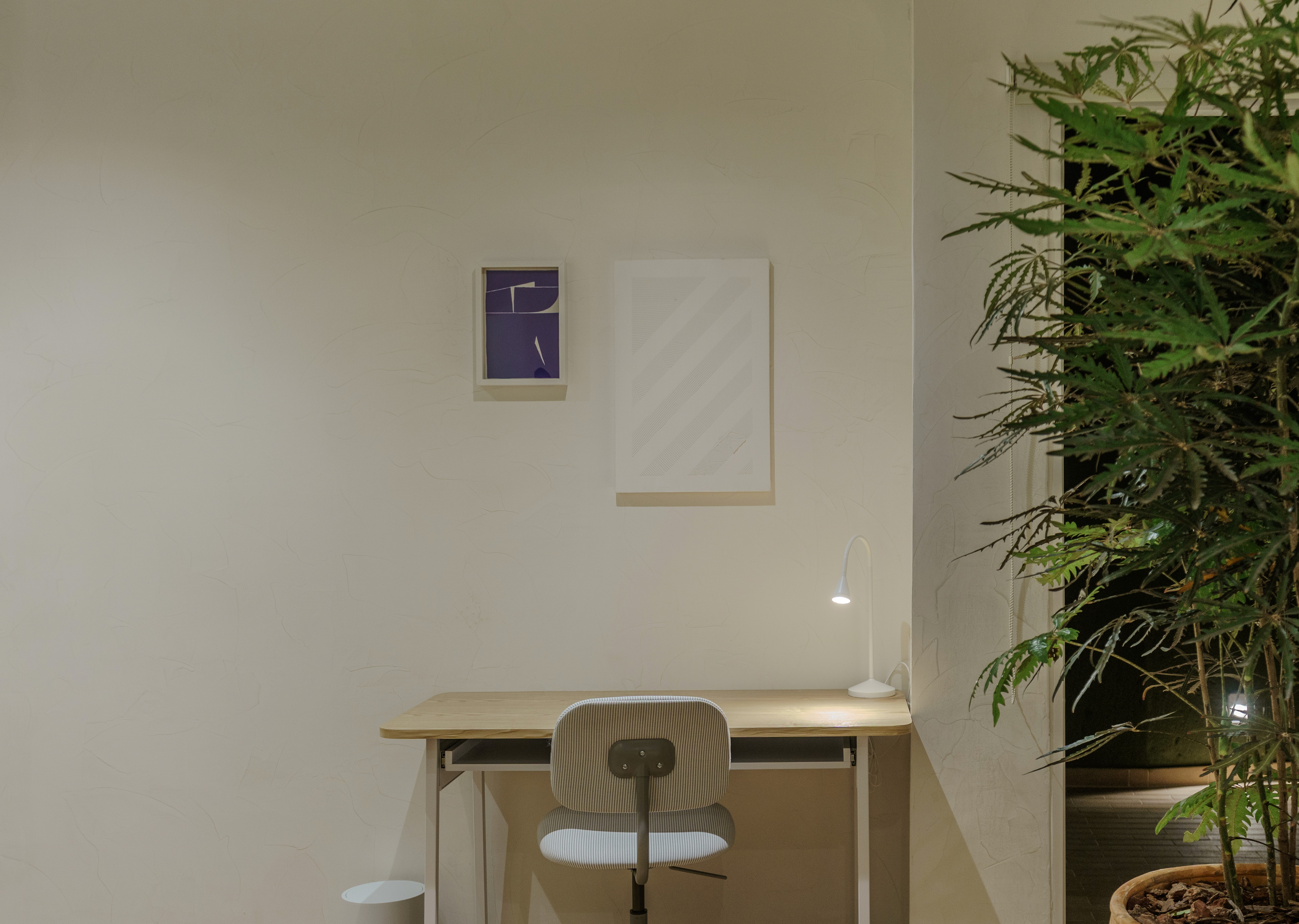Double-height interior with flowing sculptural forms and warm raking light