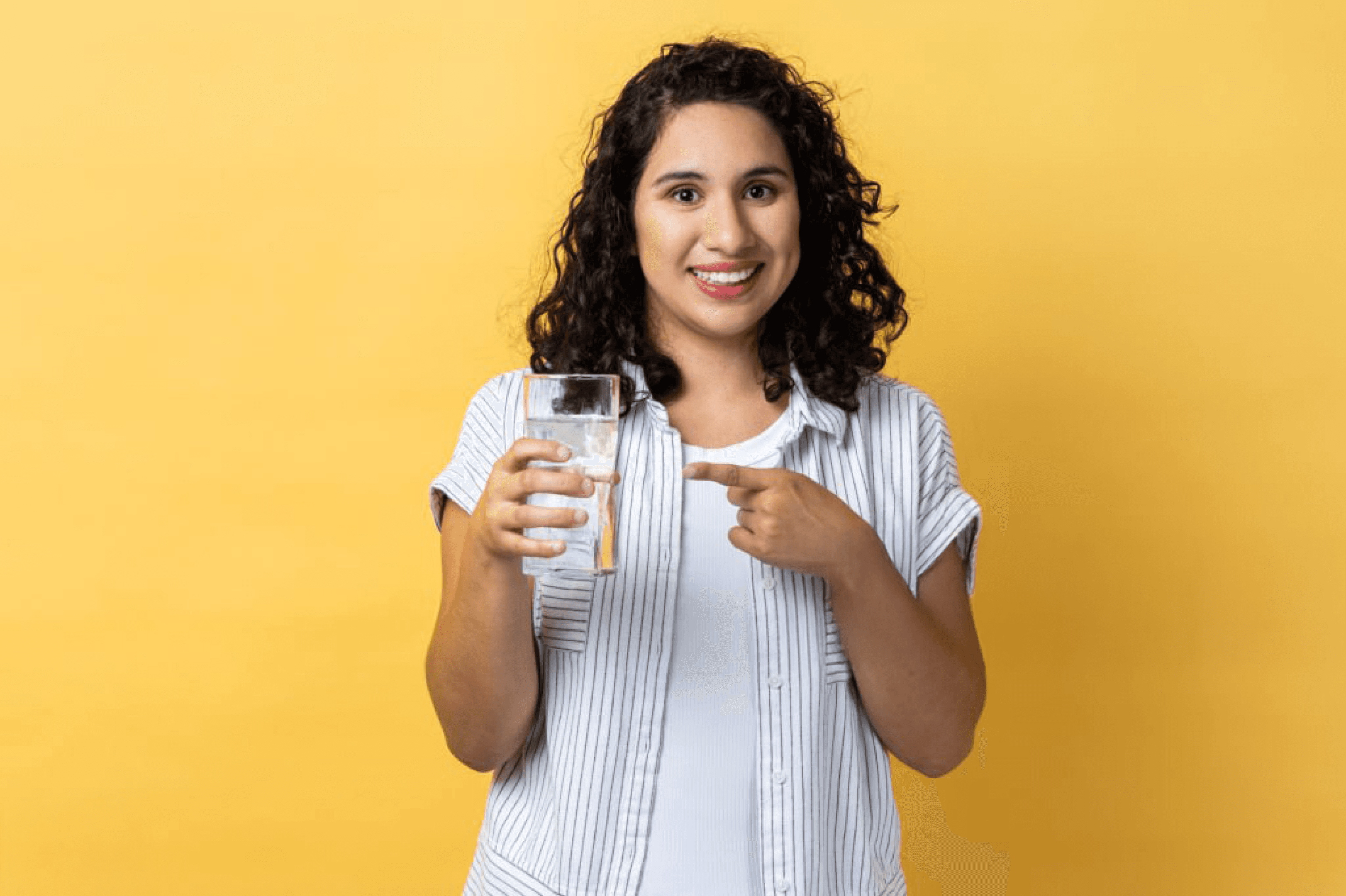 Smiling woman holding a glass of water, promoting hydration and wellnes