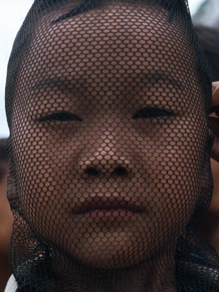 "Child's face behind a net"
