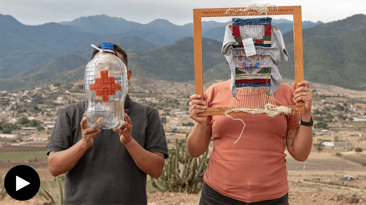 Gutierrez and Aguiniga in landscape holding artworks in front of their faces
