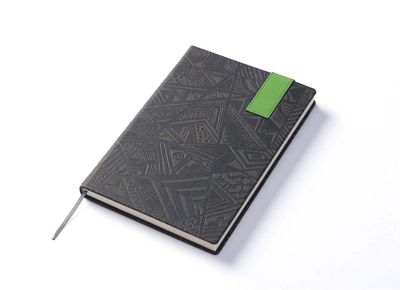 Angled view of grey geometric notebook with green strap and ribbon bookmark.