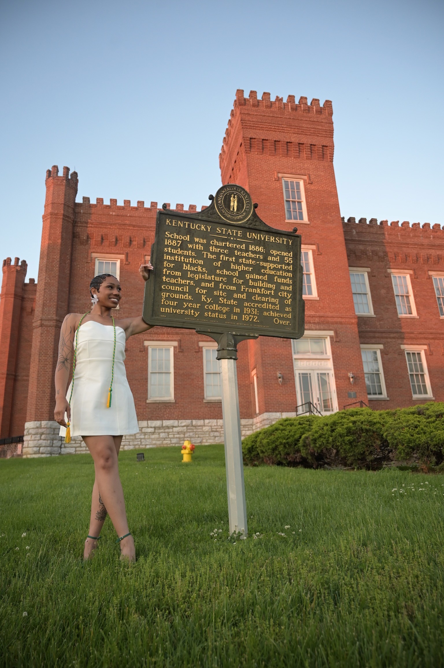 woman in white dress touching statue