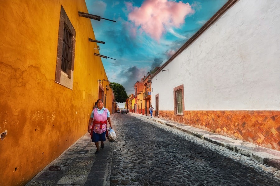 A woman walking on a colorful Mexican street