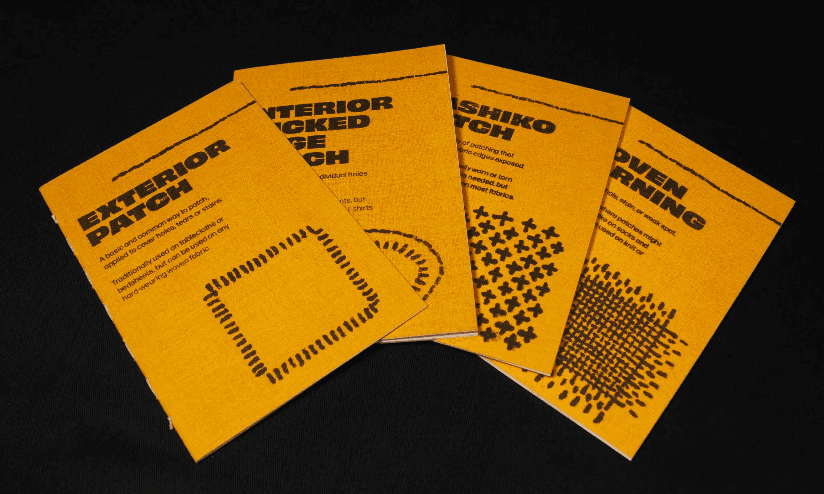Four yellow booklets about different mending techniques