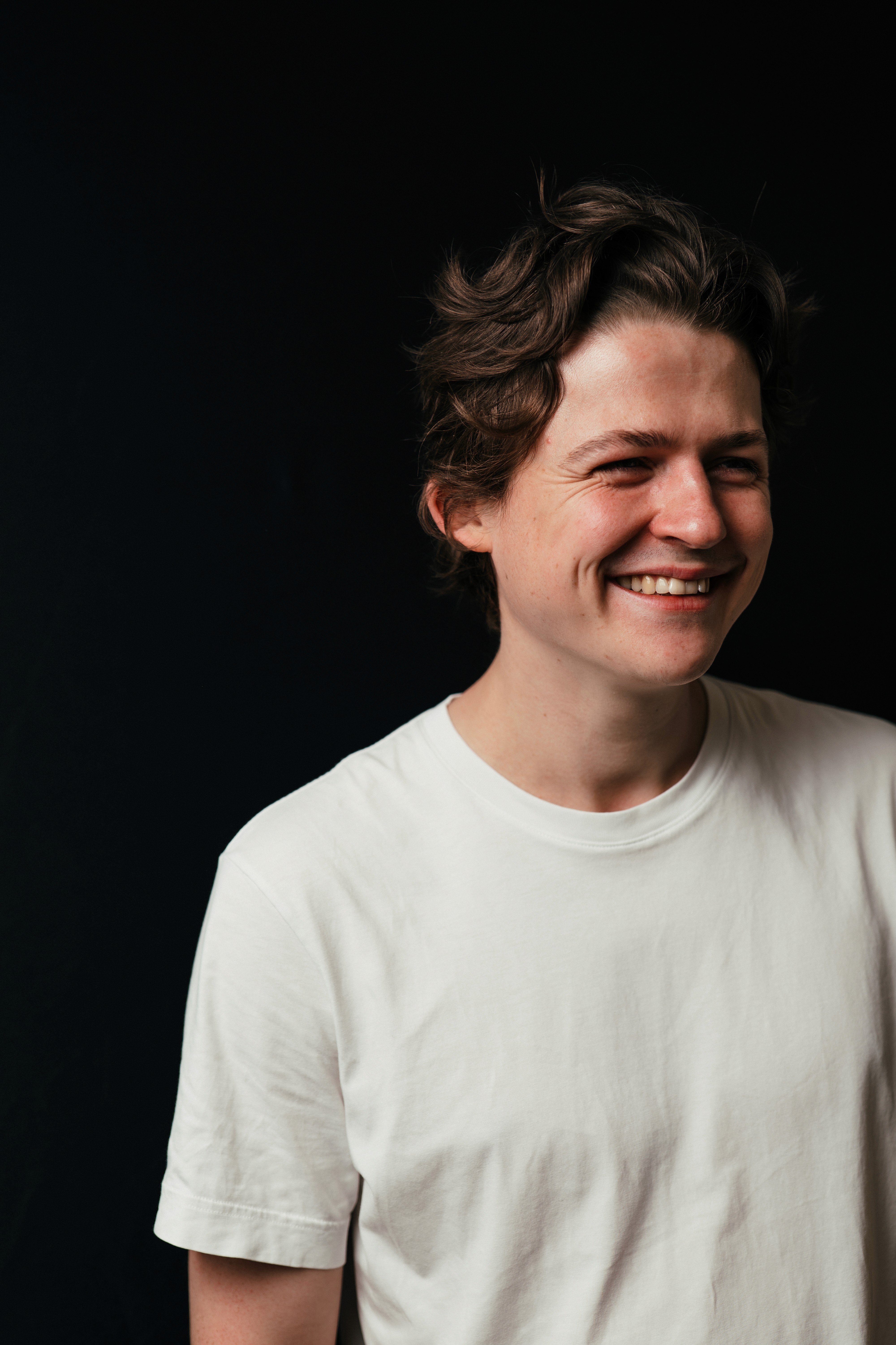 Candid portrait of a wedding videographer smiling during a relaxed moment