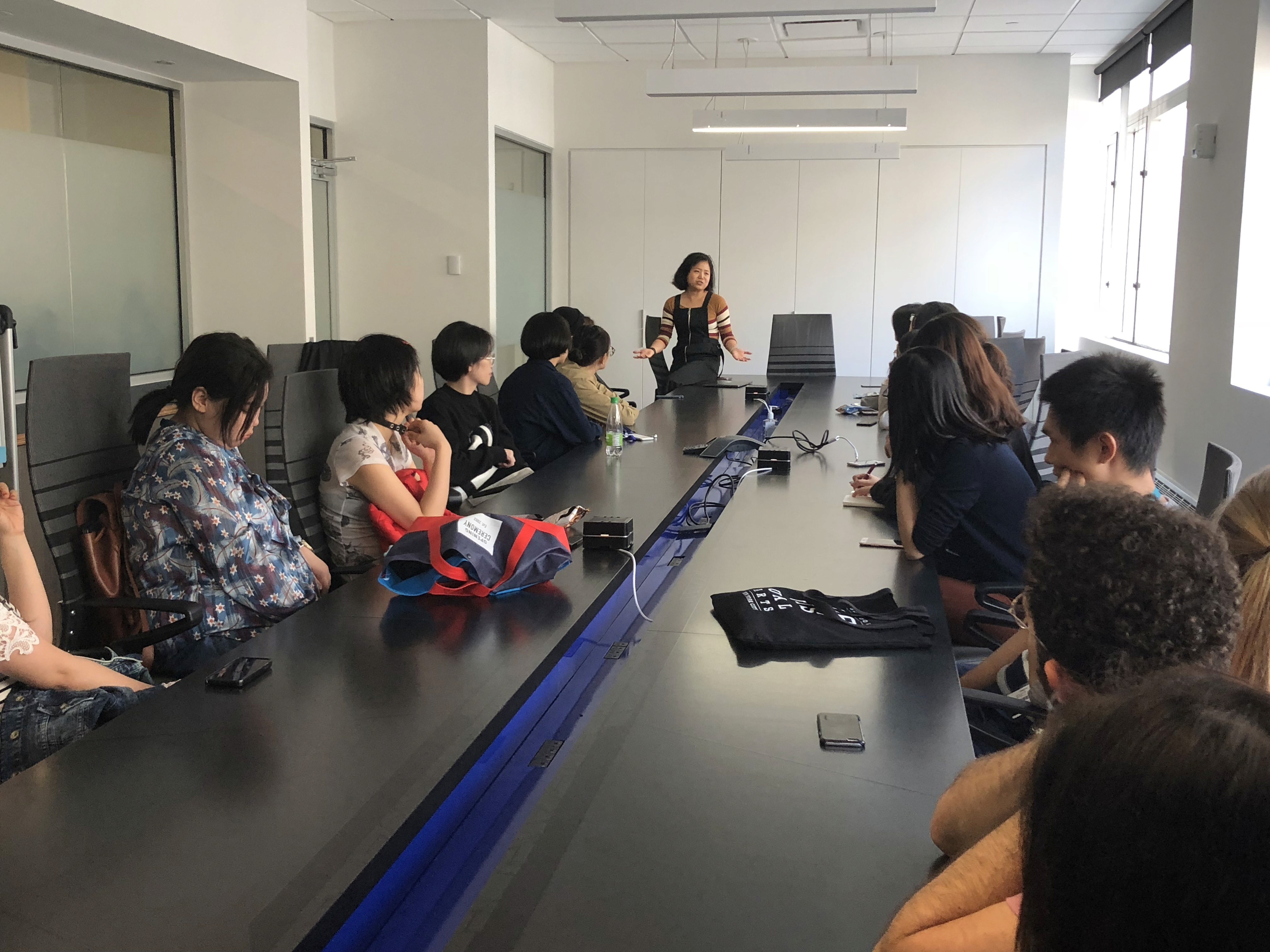 A photo of people sitting at a conference table in an office.