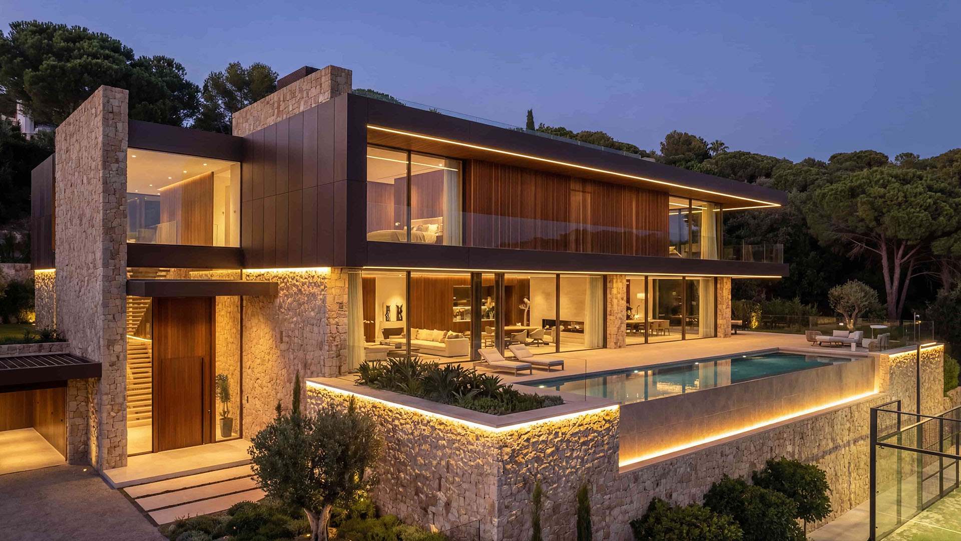 Luxury villa exterior in East Marbella with private padel court and evening lighting
