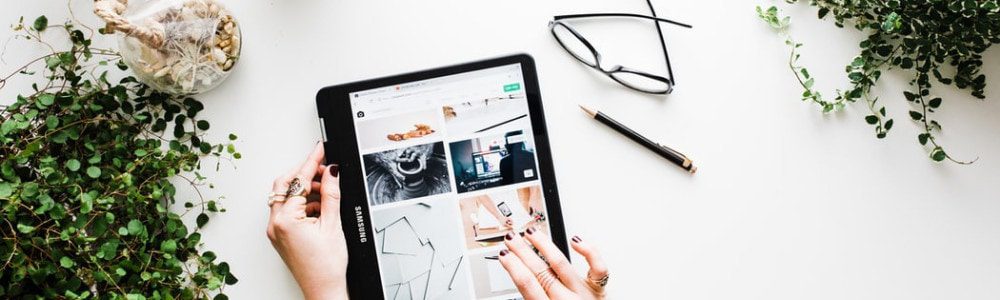 iPad, glasses and a pen on a table
