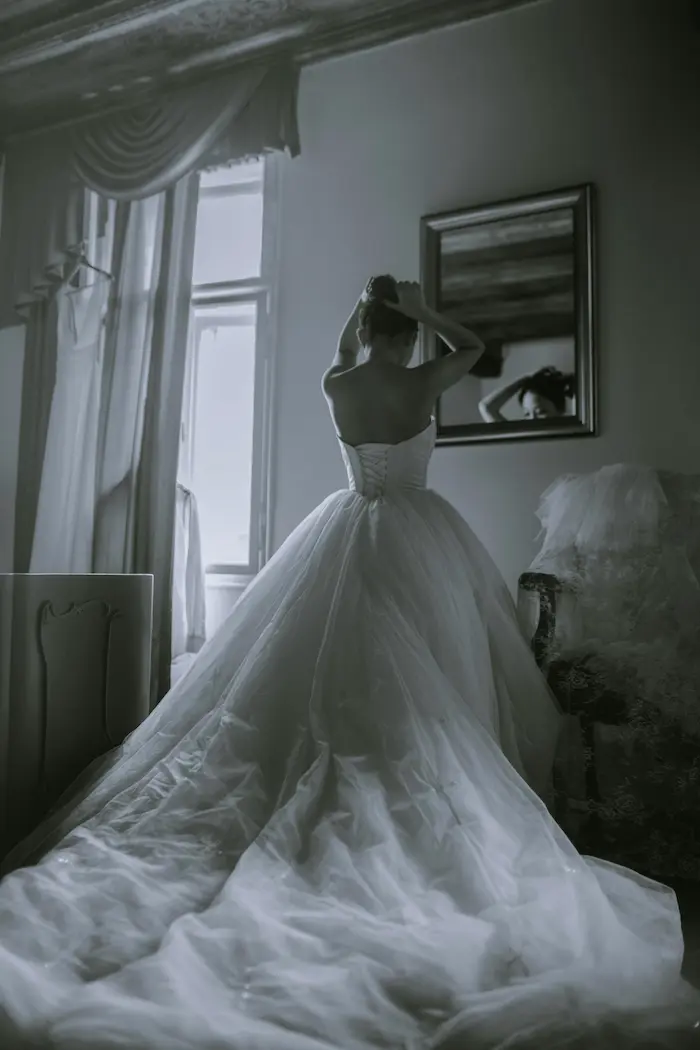 grayscale photo of woman facing on mirror