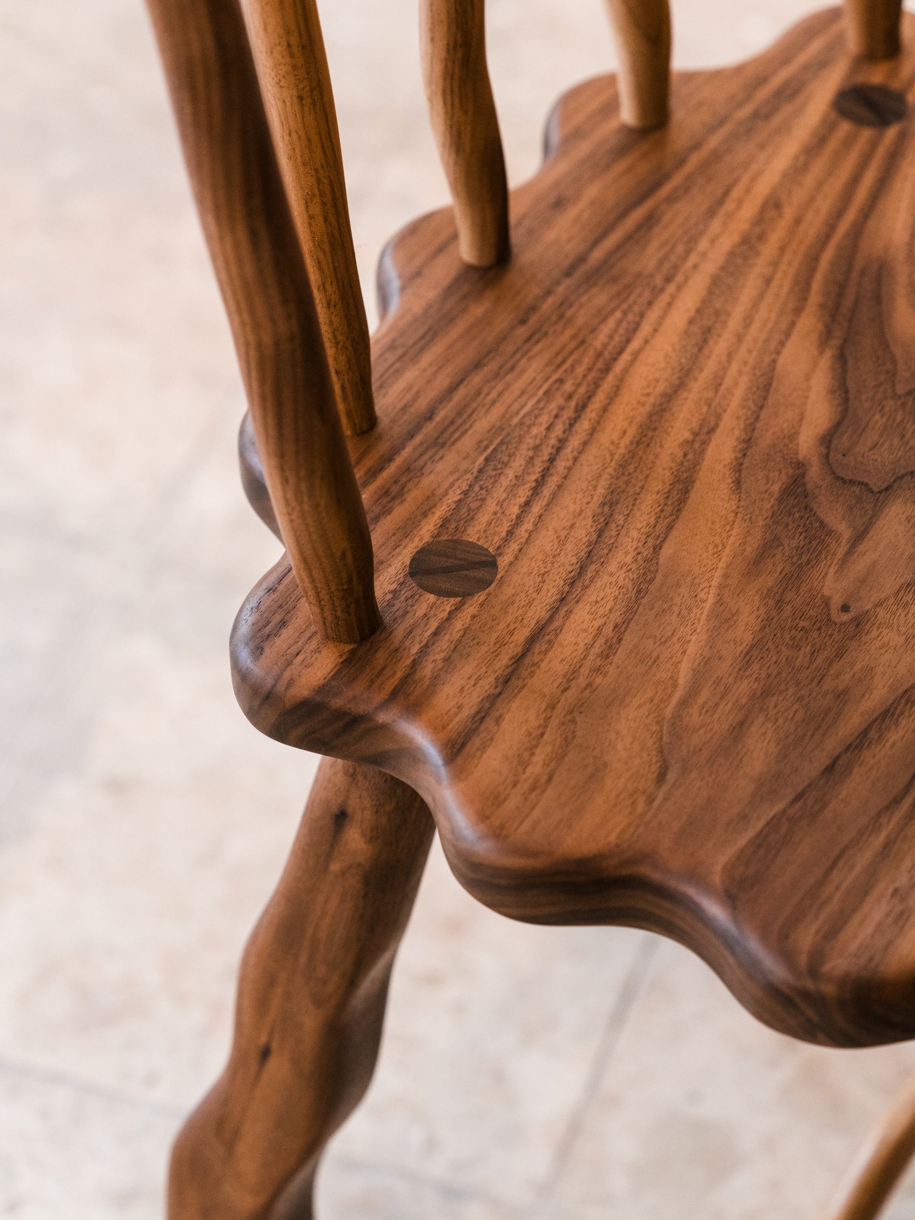 Close up of walnut Windsor dining chair exposed tenon joinery