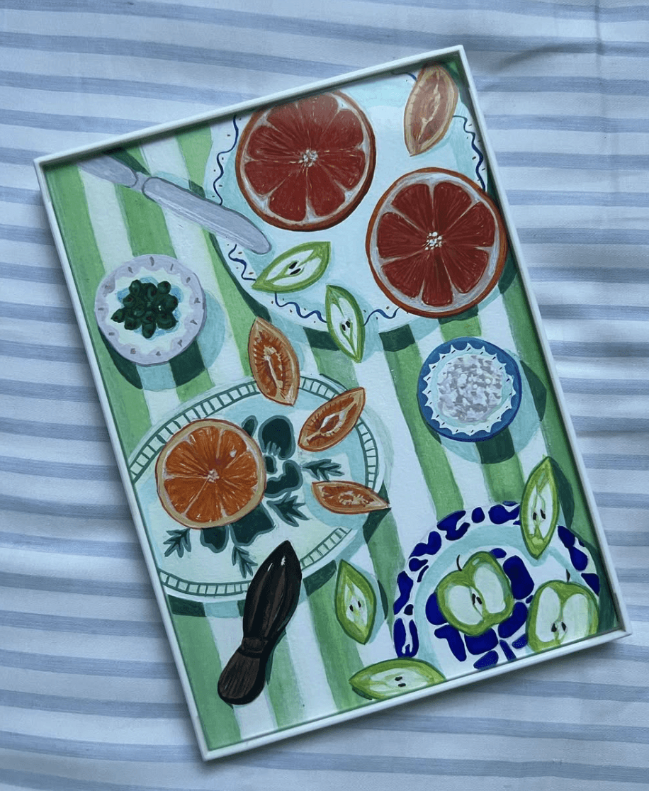 Overhead painting of a dinner table with plates and grapefruit