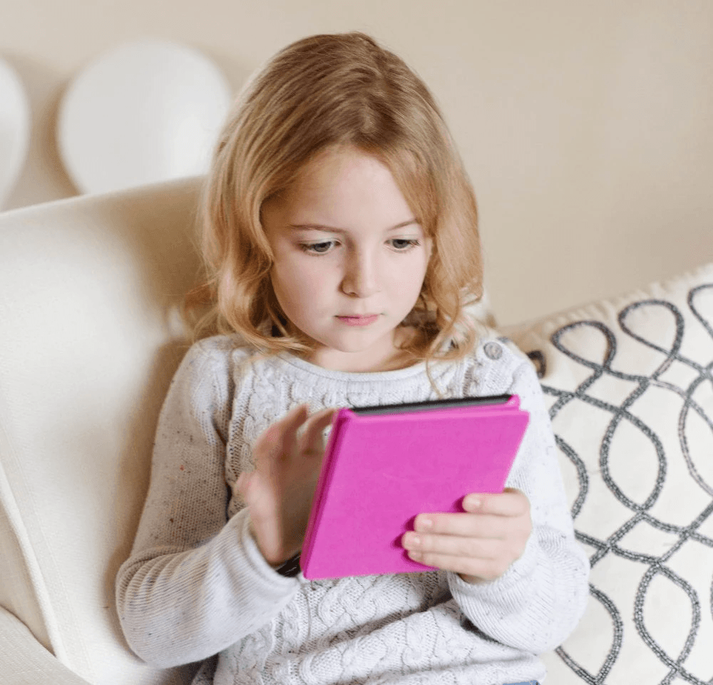 Excited child reading a CYOA story, immersed in making story decisions