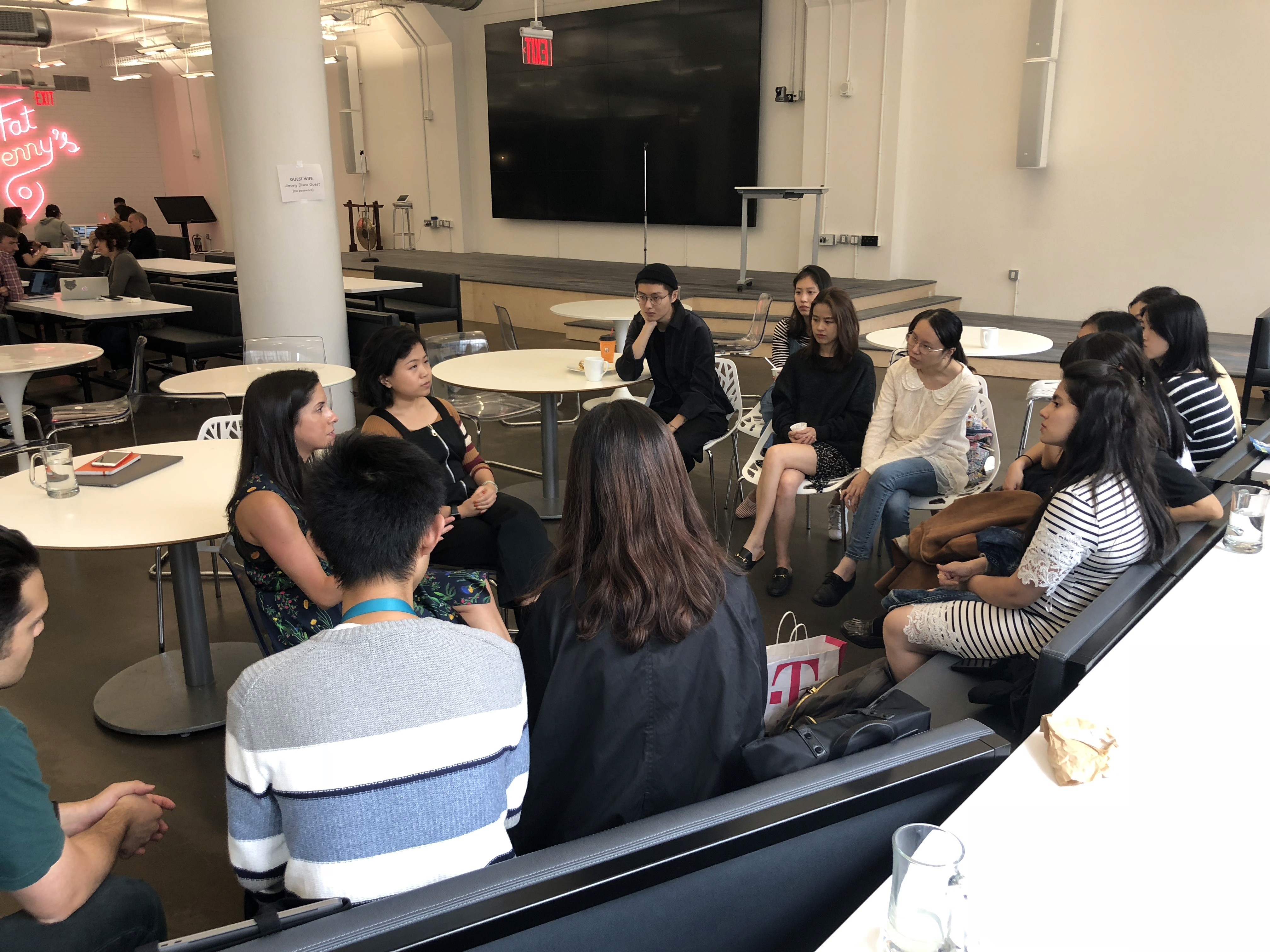People gathered in a meeting room and chatting.