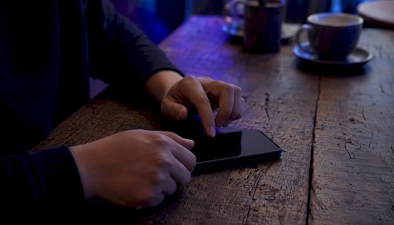 Hands using smartphone for chat and booking