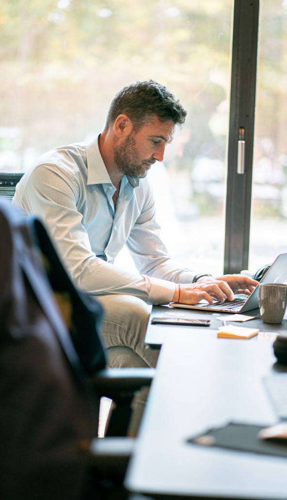 Man sitting in the office using his computer.