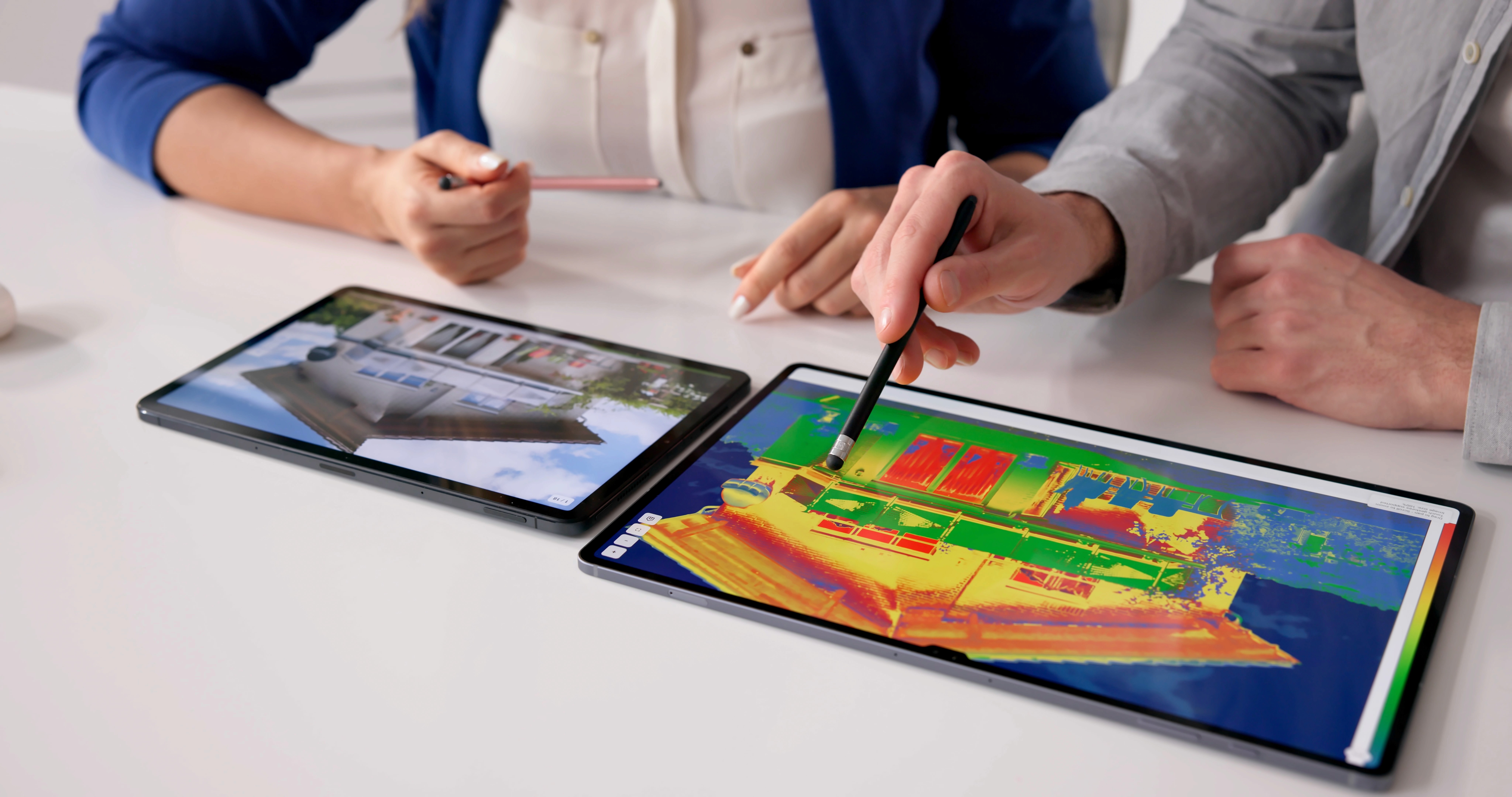 Aerial view of a winding road cutting through rocky terrain and sandy landscape.