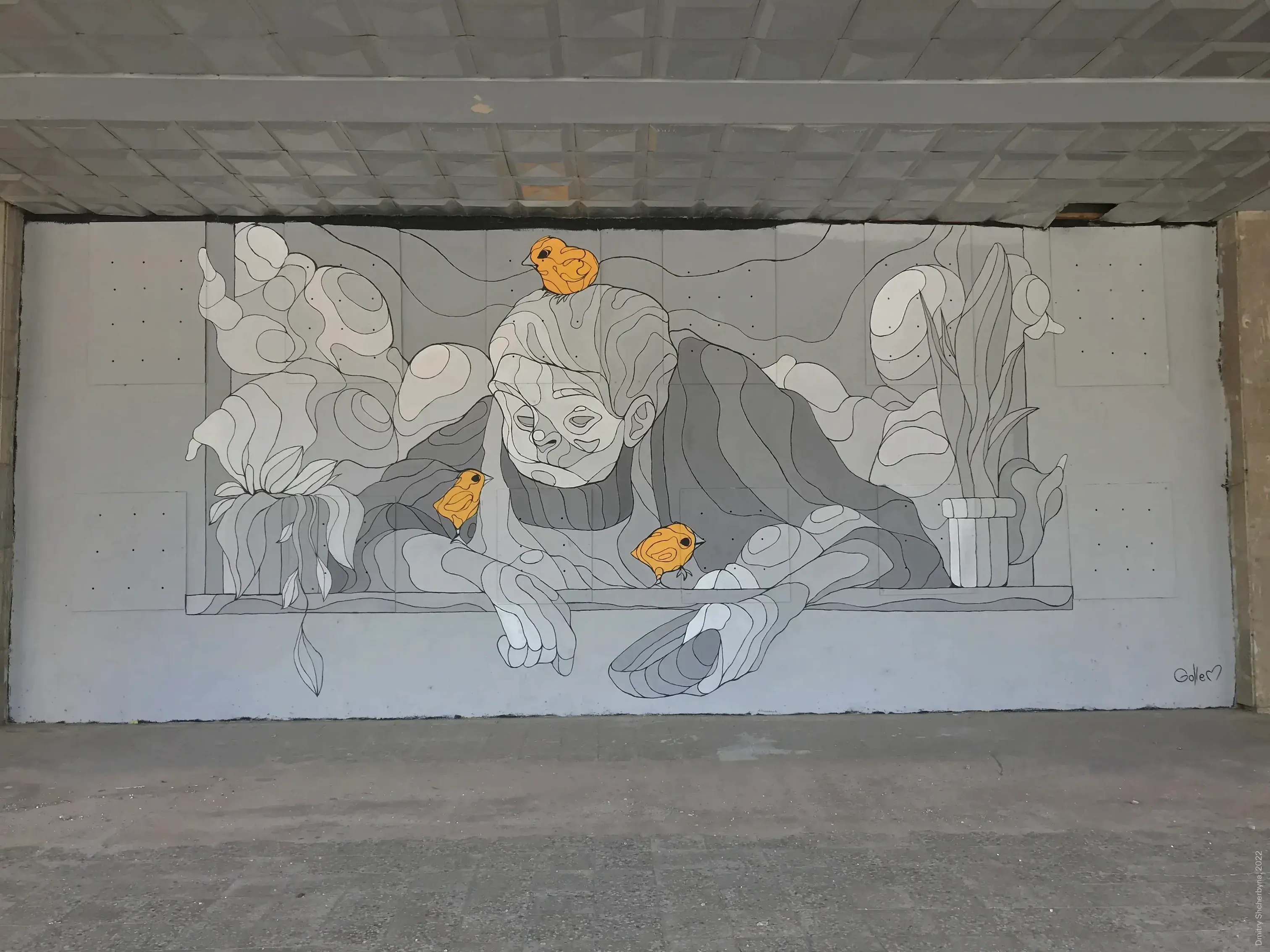 A monochrome grey mural depicts an elderly person leaning on a ledge with his hands, while three small orange chicks perch on and around him.